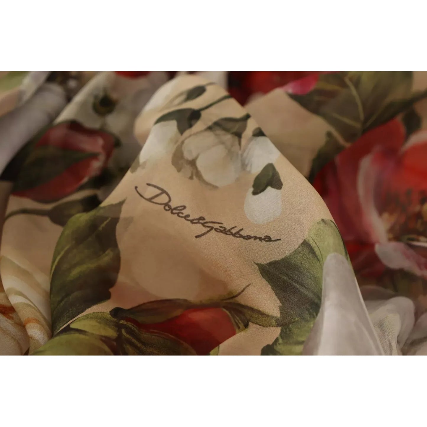 Close-up of Dolce & Gabbana Beige Floral Sleeveless A-line Mini Dress fabric with delicate floral print and logo.