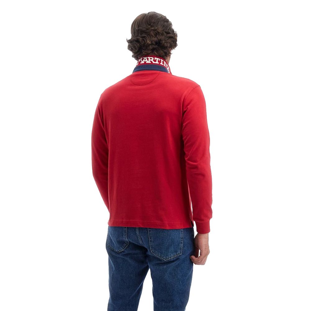 Back view of a man wearing La Martina Red Cotton Polo Shirt, featuring long sleeves and embroidered detailing, paired with jeans.