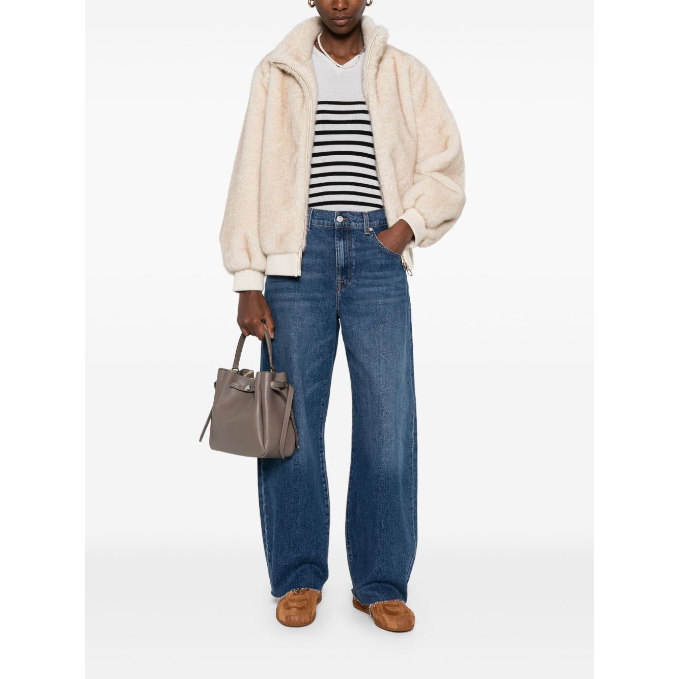 Person wearing Seven Jeans Blue with baggy fit, belt loops, and classic five-pocket design, styled with a casual outfit.