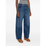 Seven Jeans Blue baggy denim with belt loops and five pockets, featuring a whiskering effect at the thighs, paired with casual shoes.