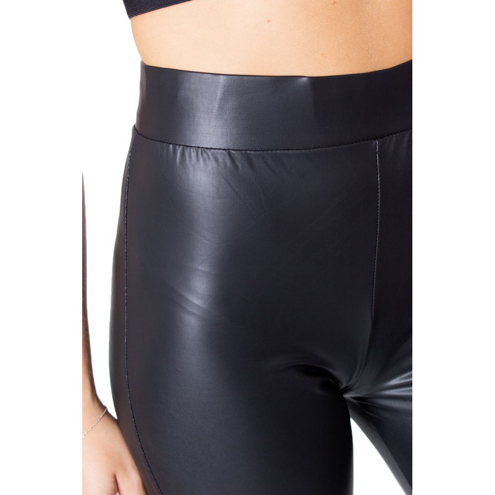 Close-up of Only Black Polyester Leggings with glossy finish, showcasing fitted design and comfort blend for stylish occasions.