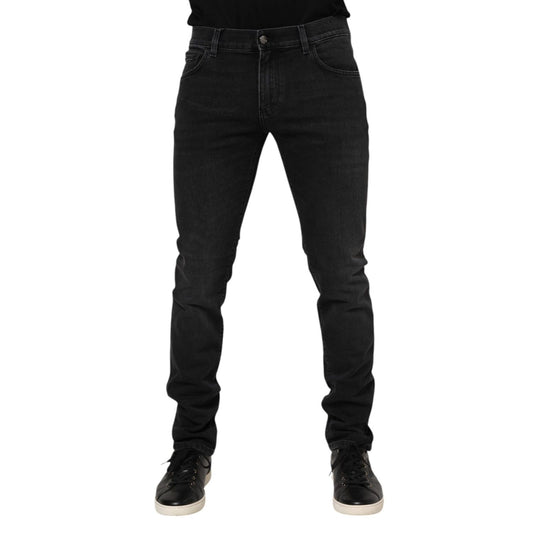 Man wearing Dolce & Gabbana Black Washed Cotton Skinny Denim Jeans with zipper closure, showcasing front view, made in Italy