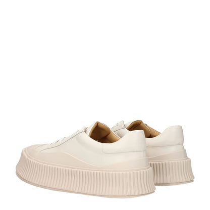 Jil Sander Beige Leather Platform Sneakers with aged effect and round toe design, featuring lace-up closure and 5cm wedge heel.
