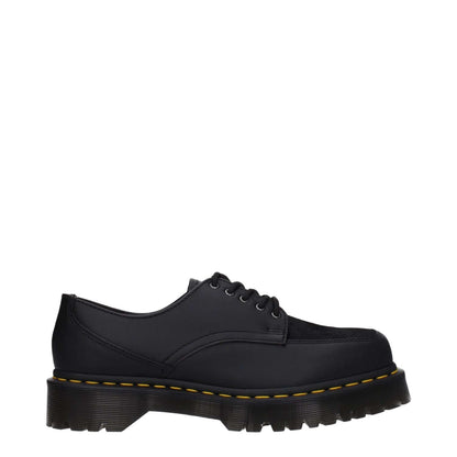 Dr. Martens Black Leather Oxfords And Derbies with rubber sole and mid heels, featuring a lace-up closure and square toe design.