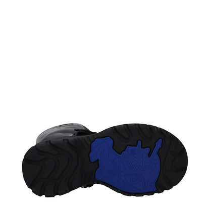 Burberry Black Leather Boots showcasing durable rubber sole with unique design pattern, round toe, and mid heels.