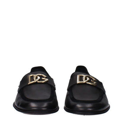 Dolce & Gabbana Black Leather Slip-On Loafers with front logo, round toe, and low flat heel, ideal for a casual style.