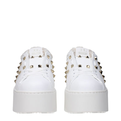 Valentino Garavani White Leather Platform Sneakers with studs, fur lining, and wedge heel, showcasing casual lace-up design.