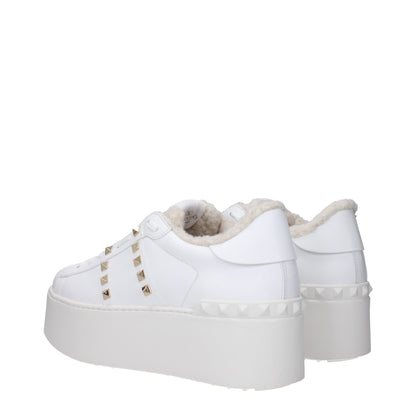 Valentino Garavani White Leather Platform Sneakers with studs, lace-up closure, and fur inside, featuring a rubber wedge sole.