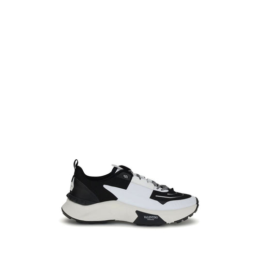 Valentino Garavani True Act Sneakers in black and white, featuring a modern mesh design and rubber sole with stud detailing.