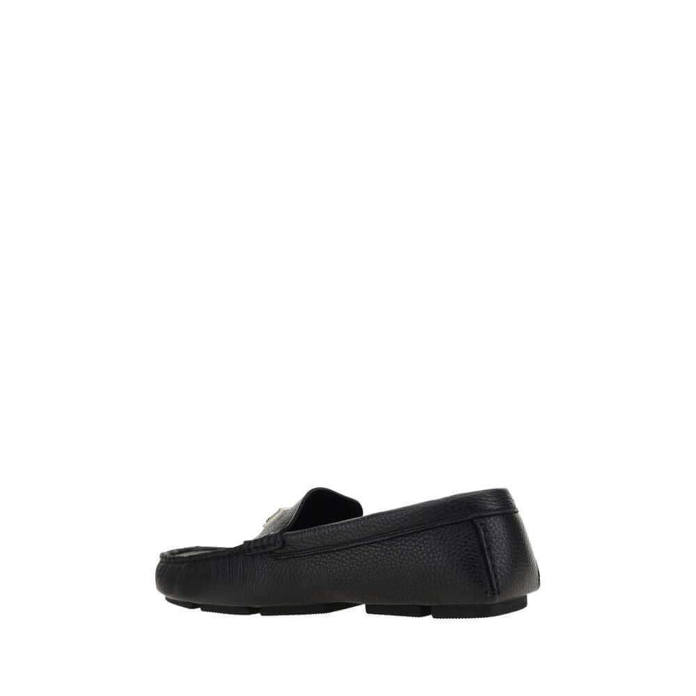 Dolce & Gabbana Black Rubber Slip-On Loafers side view with calfskin upper and non-slip sole, featuring metal monogram plaque.