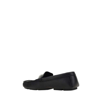 Dolce & Gabbana Black Rubber Slip-On Loafers side view with calfskin upper and non-slip sole, featuring metal monogram plaque.