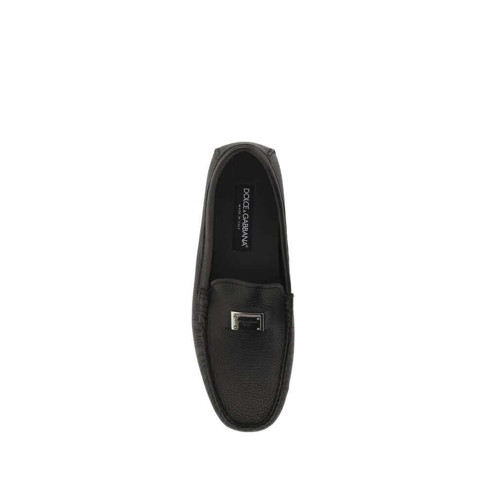 Dolce & Gabbana Black Rubber Slip-On Loafers with metal monogram plaque, top view showing calfskin finish, Fall/Winter 2025