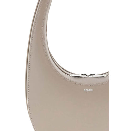 Close-up of Coperni Beige Leather Shoulder Bag with unique hobo silhouette and adjustable strap, featuring three-dimensional monogram plaque.
