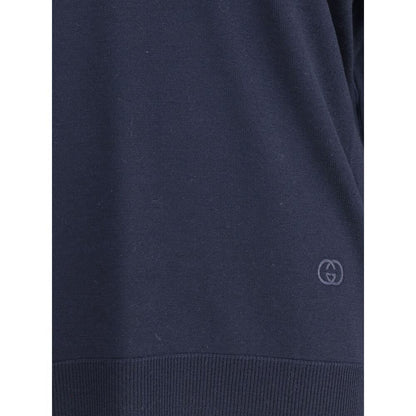 Close-up of Gucci Blue Wool Sweatshirt with embroidered logo and ribbed hem, showcasing craftsmanship and elegant design details.