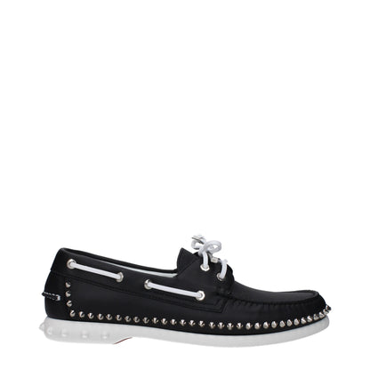Christian Louboutin Black Leather Slip-On Loafers with studs and rubber sole, lace-up closure, low flat heel, and round toe design.