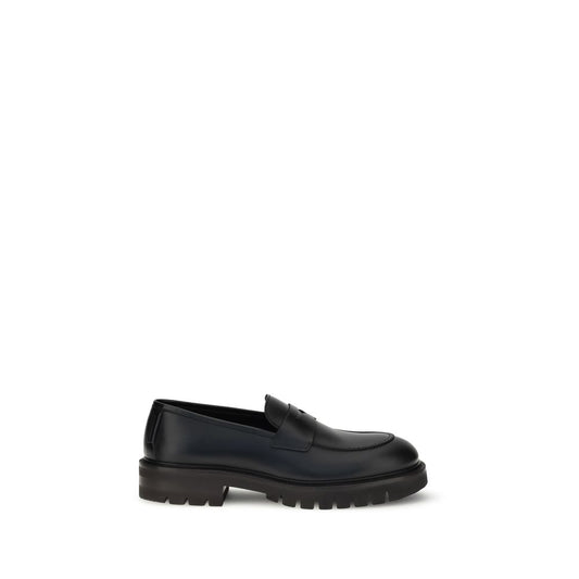 Ferragamo Black Rubber Slip-On Loafers with calfskin upper and bold lug tread sole.