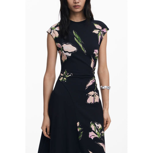 Woman wearing Desigual Black Cotton Women Dress with floral design, short sleeves, and crew neck, highlighting modern luxury and comfort.