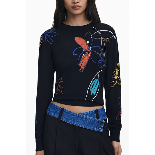 Model wearing Desigual Black Viscose Women Sweater with colorful floral patterns and blue belt.