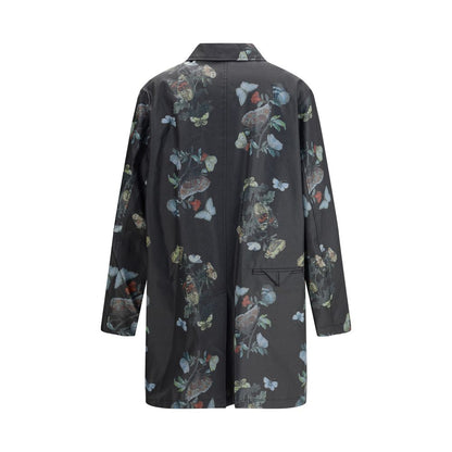 Undercover Black Cotton Coat with butterfly print, waxed finish, front flap pockets, and cotton lining, perfect for AW25 season.