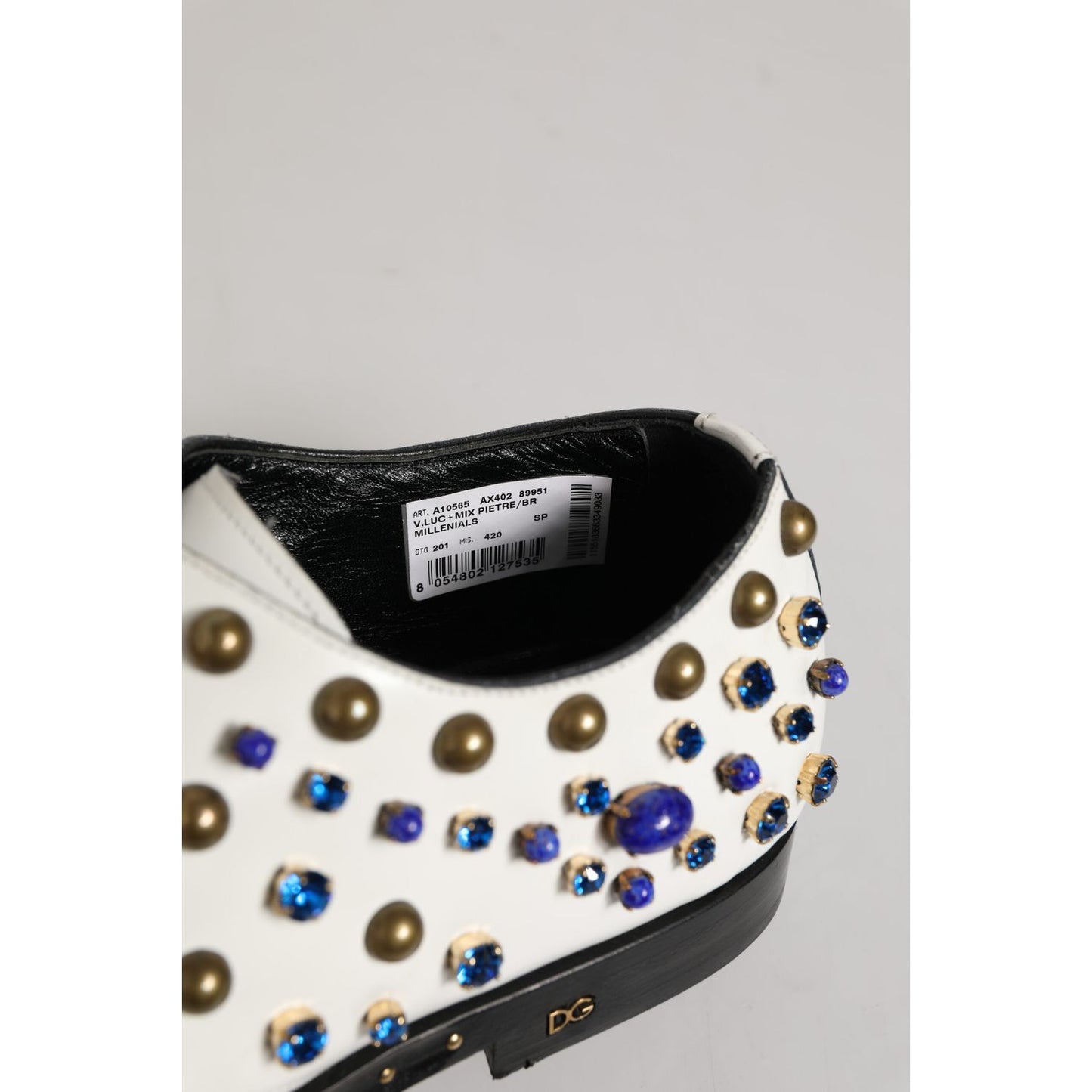 Close-up of Dolce & Gabbana White Leather Crystals Embellished Dress Shoes with multicolor crystal details on the heel.