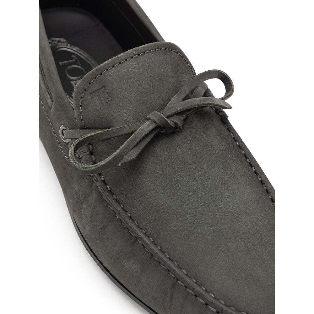 Close-up of Tod's Gray Nubuc Leather Moccassin with decorative lace and Gommino sole, showcasing Italian craftsmanship and style.