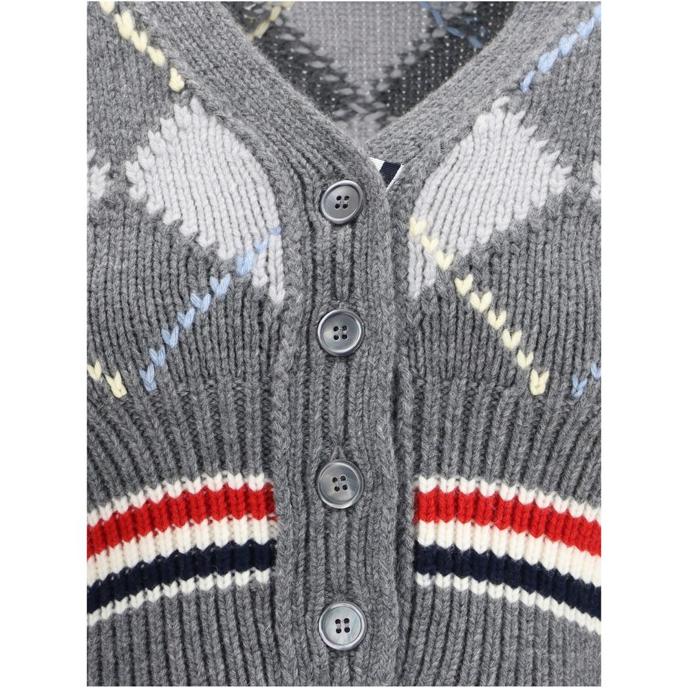 Close-up of Thom Browne Gray Fleece Wool Cardigan with argyle pattern, showcasing buttons and knit details, highlighting contemporary elegance.