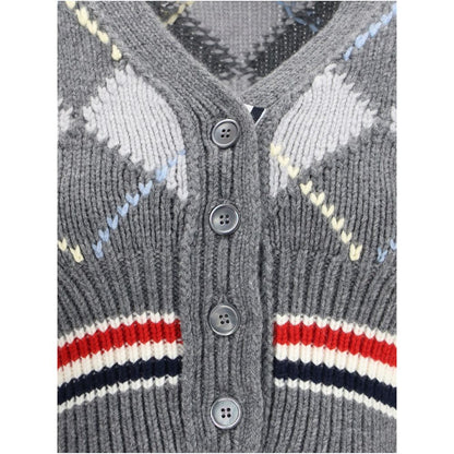 Close-up of Thom Browne Gray Fleece Wool Cardigan with argyle pattern, showcasing buttons and knit details, highlighting contemporary elegance.