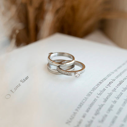 Silver rings on a book page showcasing AN JEWELS JEWELRY Mod. AR.R1NS01SC-9