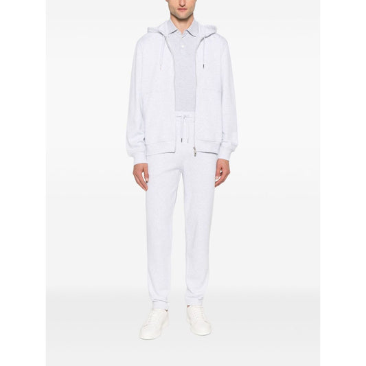 Model wearing Brunello Cucinelli Cotton track pants in light grey with elasticated drawstring waistband and side slit pockets.