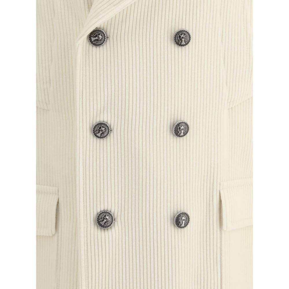 Close-up of Brunello Cucinelli Cream Cashmere Coat with ribbed texture and metal button details.