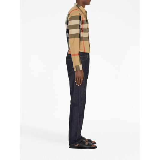 Side view of model wearing Burberry Check cotton shirt with classic collar and curved hem in archive beige.