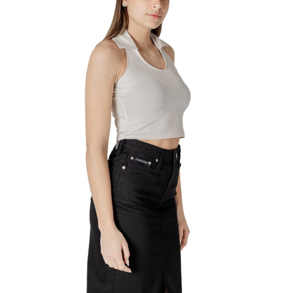 Woman wearing Calvin Klein Jeans Beige Cotton Top with halterneck polo collar, paired with high-waisted black skirt for a casual look.
