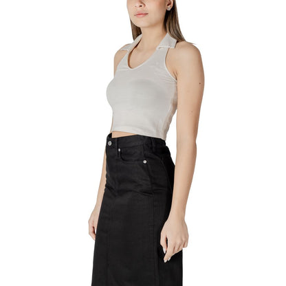 Woman wearing Calvin Klein Jeans Beige Cotton Top with halterneck polo collar, styled for a sophisticated casual look.