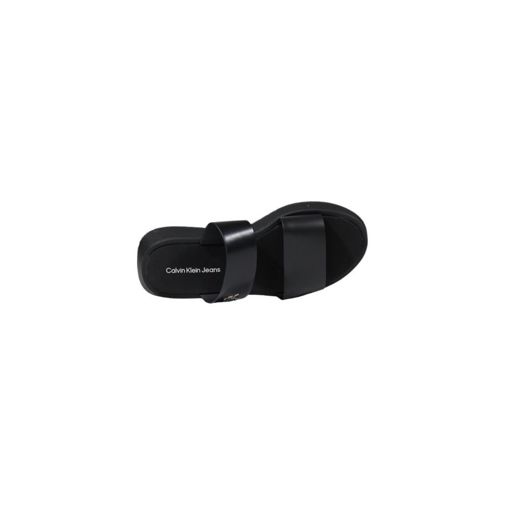 Top view of Calvin Klein Jeans Black Leather Flat Sandals showcasing minimalist design and branding on footbed.