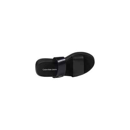Top view of Calvin Klein Jeans Black Leather Flat Sandals showcasing minimalist design and branding on footbed.