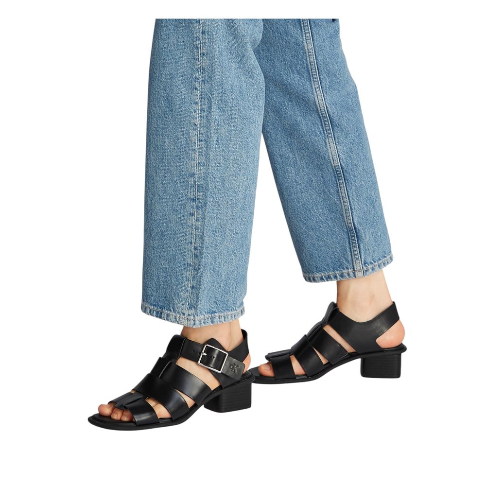 Calvin Klein Jeans Black Polyester Flat Sandals with square toe and buckle closure worn with jeans.