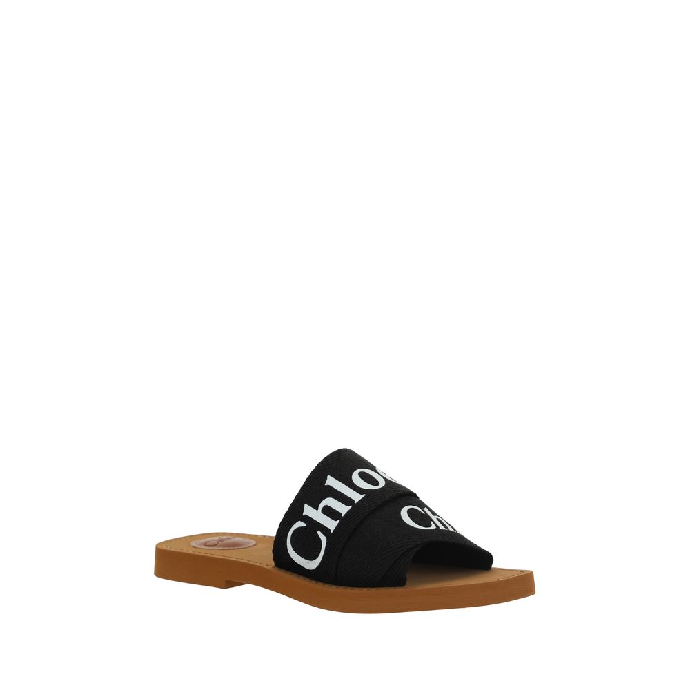 Chloé Black Rubber Sandals with branded insole, square toe, flat sole, and double fabric band featuring contrasting iconic brand signature.