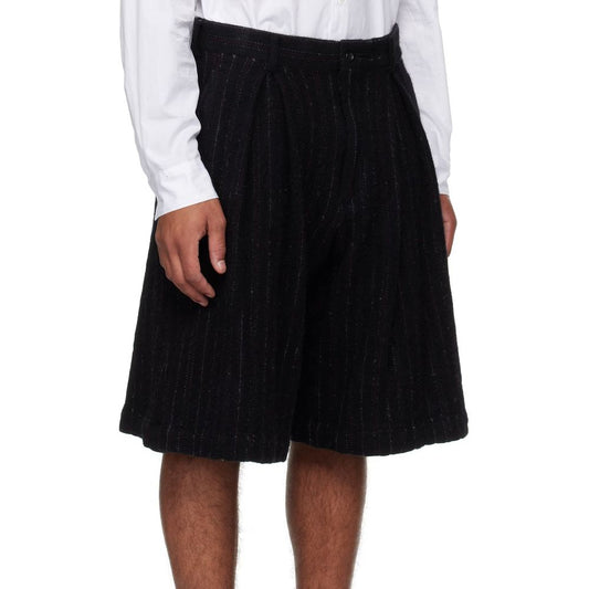 Model wearing Comme Des Garçons Homme Plus Wool Shorts with side pockets and belt loops, made of 90% wool, 10% nylon. Unlined, made in Japan.