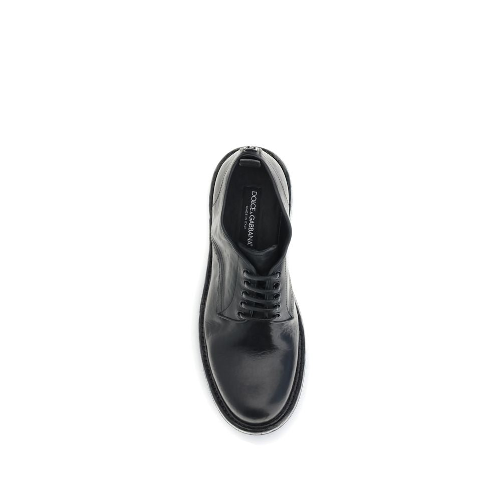 Top view of Dolce & Gabbana Black Calf Leather Bos Taurus Oxfords And Derbies with lace-up design and custom label detail.