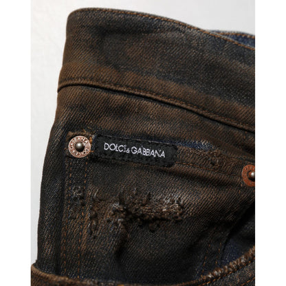 Close-up of Dolce & Gabbana Black Cotton Skinny Tattered Men Denim Jeans showing brand label and distressed details.