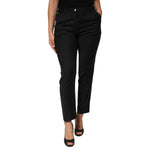 Woman wearing Dolce & Gabbana Black Polyester Tapered Women Trouser Pants with mid waist and zipper closure.