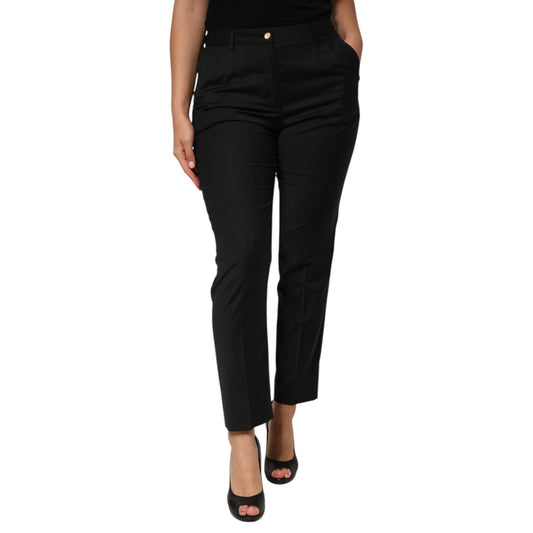 Woman wearing Dolce & Gabbana Black Polyester Tapered Women Trouser Pants with mid waist and zipper closure.