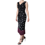 Model wearing Dolce & Gabbana Black Silk Polka Dot Vneck Tassel Midi Dress with high heels and burgundy tassel hem.