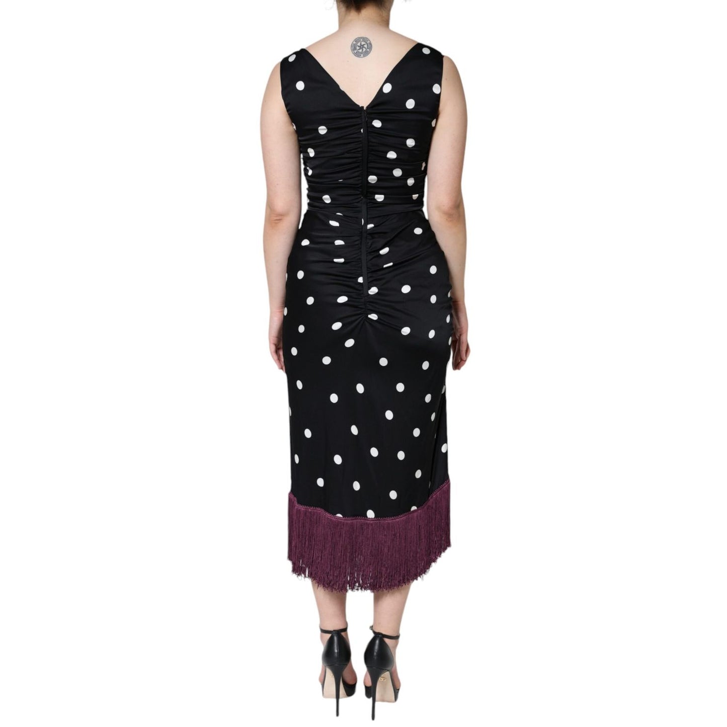 Back view of a Dolce & Gabbana Black Silk Polka Dot Vneck Tassel Midi Dress, showcasing elegant polka dots and high craftsmanship.