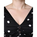 Close-up of Dolce & Gabbana Black Silk Polka Dot Vneck Tassel Midi Dress featuring detailed V-neck and elegant polka dot design.