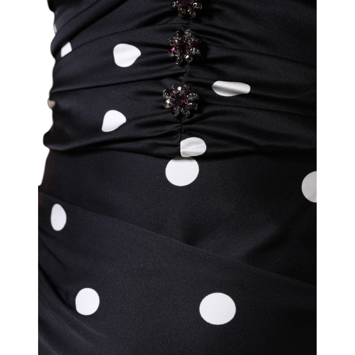 Close-up of Dolce & Gabbana Black Silk Polka Dot Vneck Tassel Midi Dress detail with white polka dots and zipper closure.