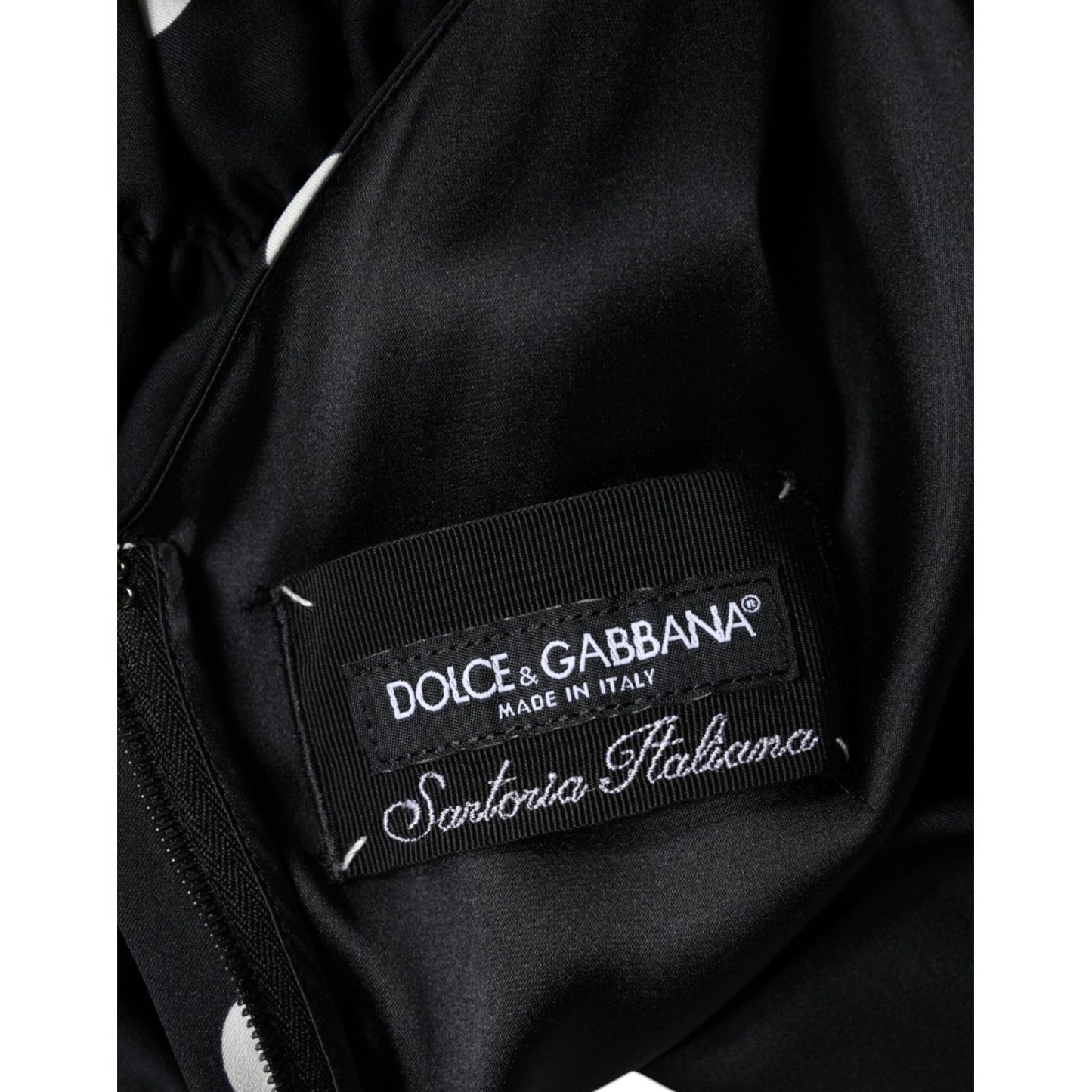 Dolce & Gabbana Black Silk Polka Dot Vneck Tassel Midi Dress interior label showing logo and craftsmanship details.