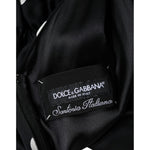 Dolce & Gabbana Black Silk Polka Dot Vneck Tassel Midi Dress interior label showing logo and craftsmanship details.