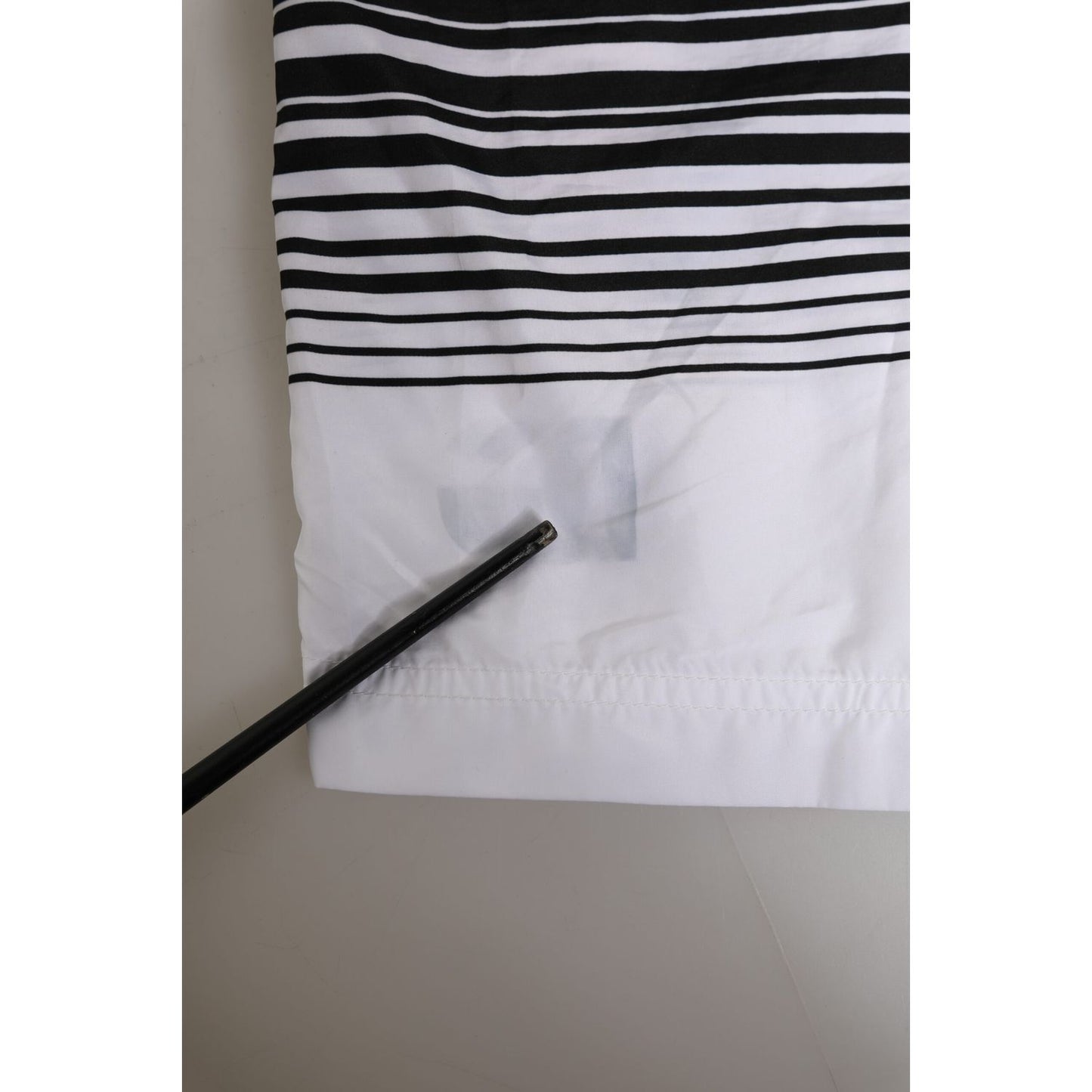 Close-up of Dolce & Gabbana Black White Striped DG Logo Men Short Swimwear highlighting the fabric and logo.