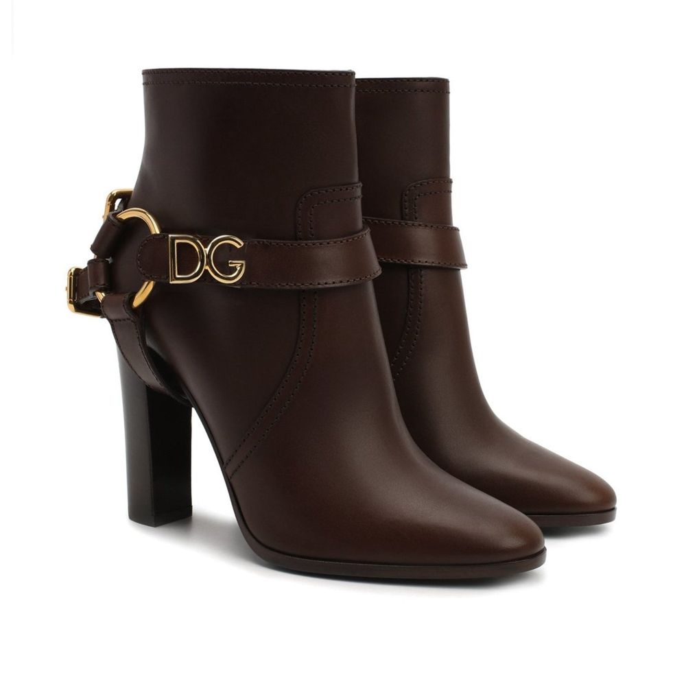Dolce & Gabbana Brown Leather Ankle Boots with gold accent and round toe, featuring zip fastening and detachable name tag, made in Italy.